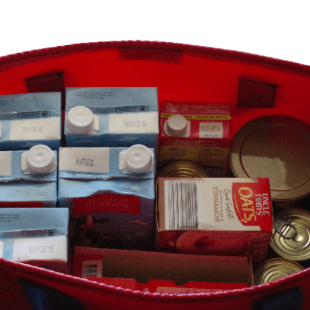 Reusable large tote bag made from durable PVC with reinforced handles for carrying shopping and supplies. Loaded with groceries.