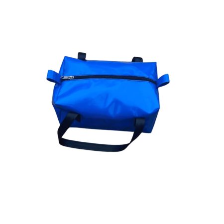 Practical Dust & Iron camping toiletry bag – water-resistant PVC design with reinforced handles, perfect for caravans and camping trips. Sitting on a pathway of rocks