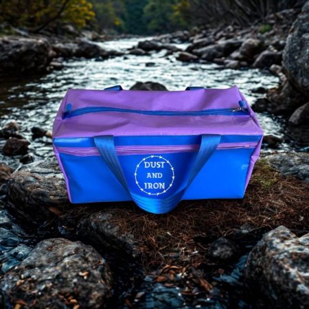 Small PVC vinyl gear bag with side pocket, reinforced handles, and heavy-duty zip, ideal for travel, camping, or sports gear storage.