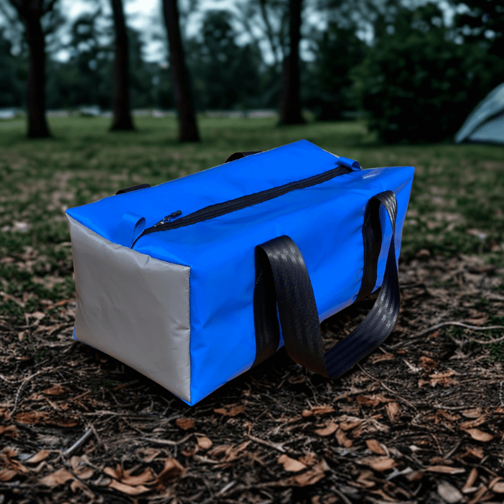 Overnight gear bag made from durable water-resistant PVC vinyl with heavy-duty zips and reinforced seatbelt webbing handles – ideal for weekend travel or kids’ sports gear.