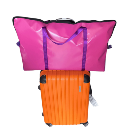 Durable PVC pillow carry bag, lightweight and stylish, designed to hang over luggage handles for easy travel.Pink and purple pillow carry bag.