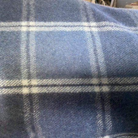 “Light blue check wool lining inside saddle gear bag – eco-friendly recycled wool fabric”