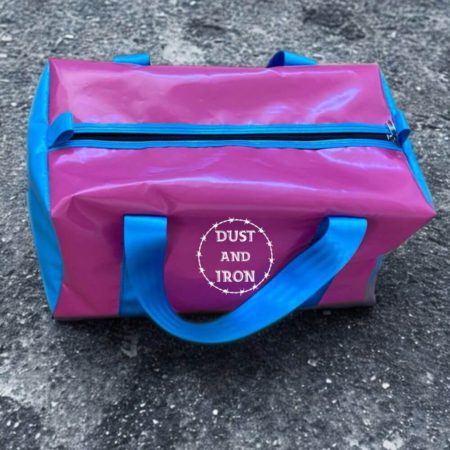 Compact PVC vinyl gear bag with rugged design, perfect for carrying essentials for work, sports, camping, or short getaways.
