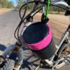 Dust & Iron PVC swinging toilet roll holder bag hanging outdoors, keeping paper clean and dry for camping and caravans. Hanging from a bike