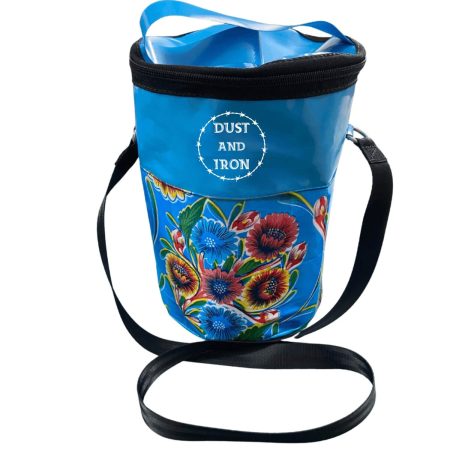 Blue oilcloth patterned shower mate bag with shoulder strap and Dust & Iron branding